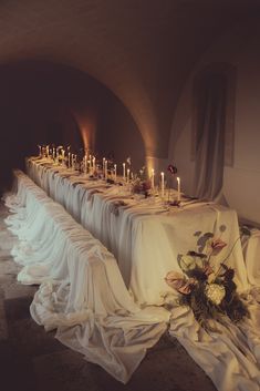 a long table is set with candles and flowers