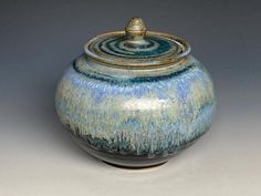 a blue and green pot with a lid