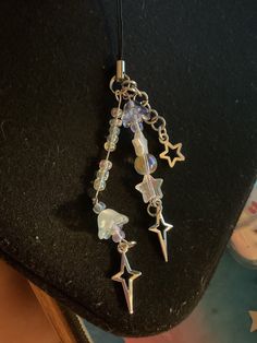 a necklace with stars and beads hanging from it