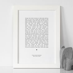 an elephant statue next to a framed poem