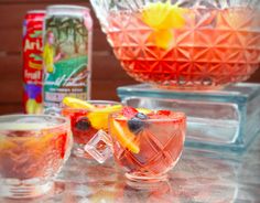 two glasses filled with drinks sitting on top of a table