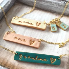 three different necklaces that say mama, i love you and grandma with hearts on them