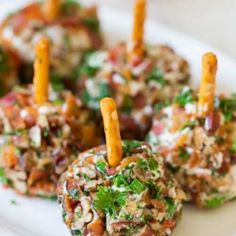 several appetizers are arranged on a plate with toothpicks sticking out of them