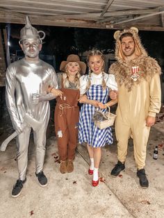 three people in costumes standing next to each other