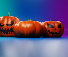 three jack o lantern pumpkins sitting on top of a table next to each other