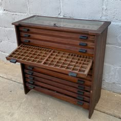 a wooden cabinet with drawers on the outside