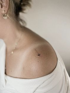 a woman with a small tattoo on her shoulder