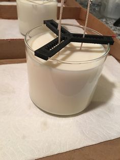 two glasses filled with milk sitting on top of a table