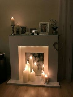 a fireplace with lit candles in front of it