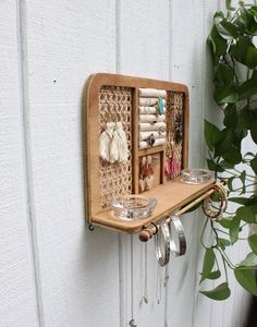 a wall mounted jewelry organizer on the side of a building