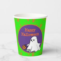 a paper cup with a ghost and pumpkin on the front that says happy halloween in orange, green, and purple