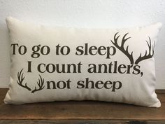 a pillow that says to go to sleep i count antlers, not sheep