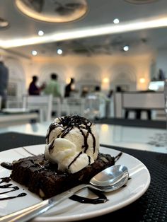 a white plate topped with chocolate cake and ice cream