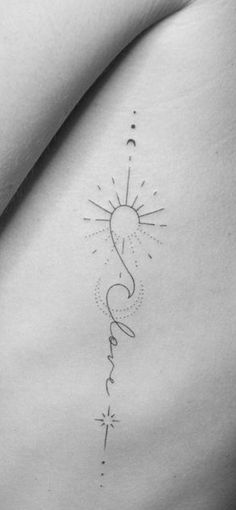 the back of a woman's stomach with a sun and stars tattoo on it