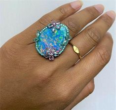 LAST CALL, LAST CHANCE!!! LIQUIDATION SALE!!!The Following Item we are offering is a Rare Important Radiant 18KT Gold Glistening Australian Black Opal and Diamond Gorgeous Ring. Ring features a Magnificent Rare Color Changing Black Opal from Australia adorned with Outstanding Brilliant Rose Cut Diamonds surrounded with a Halo of Glittering Diamonds!!! Stones are Very Clean and Extremely Fine! Approx T.C.W. for Ring 22CTS!! NWT $28,000. Comes with Certificate from the GAL Gemological Appraisal La Boulder Opal Jewelry, Rose Cut Diamond Ring, Diamond Rings With Price, Australian Black Opal, Rosecut Diamond Ring, Ethiopian Opal Ring, Precious Opal, Liquidation Sale, Baguette Diamond Rings