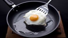 an egg is on top of a piece of bread with a fork in the middle