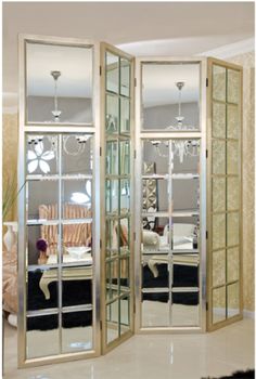 a room divider with mirrored doors in it