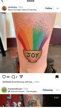 the tattoo is on someone's leg and it looks like they have rainbow colors