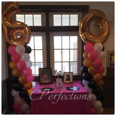 a table with balloons and pictures on it