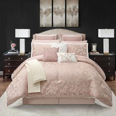 a bedroom with black walls and pink bedding