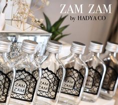 several small bottles are lined up on a table with the name zamzam by hadyaco