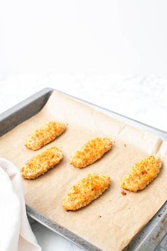 four chicken patties on a baking sheet ready to go into the oven in the oven