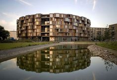 an apartment building is reflected in the water