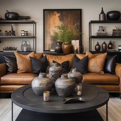 a living room filled with lots of furniture and vases on top of a table