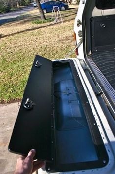 the back end of a white truck with an open trunk