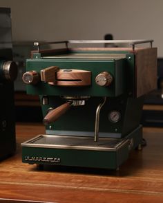 an espresso machine sitting on top of a wooden table