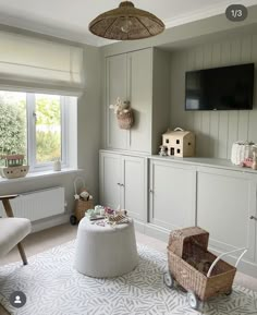 a living room filled with furniture and a flat screen tv mounted to the side of a wall