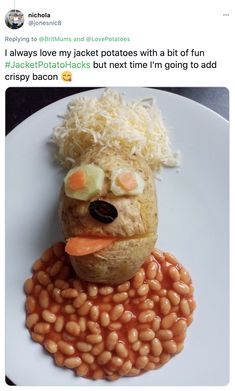 a white plate topped with beans covered in rice and carrots next to a stuffed animal