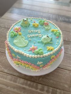 there is a blue cake with green frosting on the top that says stay sweet