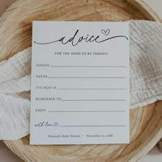 an advice card on top of a wooden plate with white napkins next to it