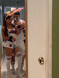 a man and woman in costume taking a selfie