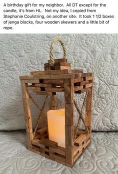 a small wooden lantern with a lit candle inside