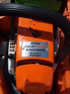 an orange lawn mower with the words still on it