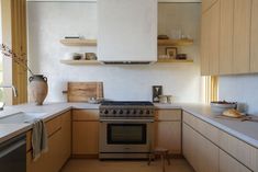 a kitchen with an oven, sink and counter tops in the middle of the room