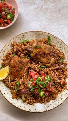 a white plate topped with rice and meat