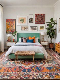 a bedroom with lots of pictures on the wall above the bed and an ottoman in front of it