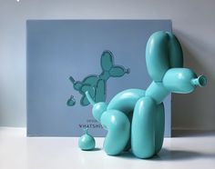 a blue balloon dog sitting on top of a table