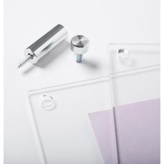 a pair of ear buds sitting on top of a piece of paper next to a pen