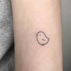 a small bird tattoo on the arm