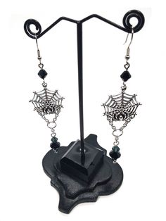 Made to Order! This earring set features a spider on its web. Perhaps it is reeling in its tangled prey? They can be worn with Gothic, fantasy inspired, steampunk or any other outfits you wish. This elegant design is the perfect pair with one of my necklaces or rosary chains! They also go really well with layers of stacked silver statement necklaces. These earrings make a perfect gift for someone who loves spiders and insects or ornate silver toned jewelry. Each earring weighs approx. .2 oz. ﻿Th Handmade Punk Style Costume Jewelry, Black Fantasy Jewelry For Costume Party, Fantasy Black Jewelry For Costume Party, Punk Style Handmade Costume Jewelry, Steampunk Jewelry For Halloween Cosplay, Black Fantasy Style Pierced Earrings, Black Fantasy Earrings, Black Fantasy Style Earrings, Halloween Steampunk Metal Jewelry