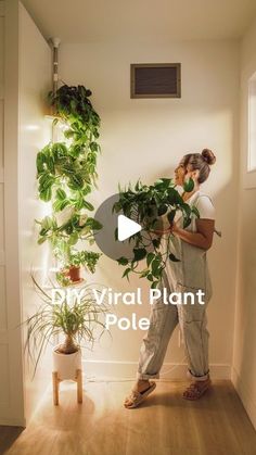 a woman standing in front of a plant with the words dm virtual plant pole