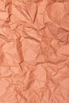 an orange piece of paper that is crumpled in half