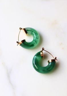 Inspired by the tranquility of hidden lagoons, the Emerald Lagoon Earrings showcase lush green jade set against gold accents, offering a serene touch of the sea to your style. Material: Stainless Steel Waterproof: Yes Hypoallergenic: Suitable for sensitive skin Durability: Non-tarnish Each of our products is beautifully packaged in an elegant, reusable, and recyclable jewellery box, ready for gifting. Ocean Inspired Jewelry, Jade Earrings, Ocean Inspiration, Green Jade, Lush Green, Jade Green, Jewelry Earrings Hoops, Gold Accents, Sensitive Skin