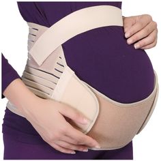 a pregnant woman holding her belly with an over - sized belt attached to the waist