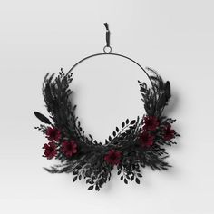 a black and red floral wreath hanging on a wall