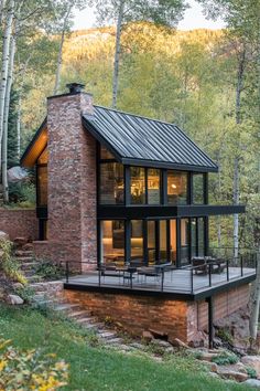 a modern cabin in the woods surrounded by trees